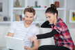 © auremar - Couple on sofa looking at laptop