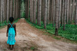 © Gabriel (Gabi) Bucataru/Stocksy - African American girl in blue dress on a road in the forest