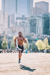 © aremafoto/Stocksy - Male athlete running in an urban area