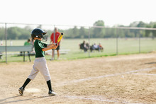 Boy Swinging A Baseball Bat