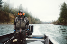 Fly Fisherman Drives A Jet Boat Up River In Pursuit Of Steelhead.