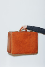 Man Holding Retro Leather Luggage / Suitcase
