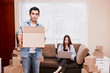 © Art_Photo - Young couple with cardboard box at home - Business online and delivery concept