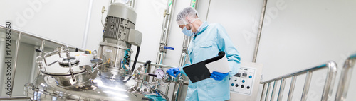 Fotomural scientist is working with control panel