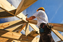 Roofer ,carpenter Working On Roof Structure At Construction Site
