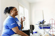 © Roberto Westbrook/Blend Images - Black volunteer woman drinking water