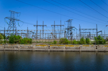 High voltage power lines and towers against sky