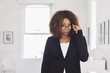 © Strauss/Curtis/Blend Images - Mixed race woman peering over eyeglasses in gallery
