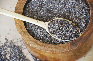 Chia seed in a wooden spoon on the table. Healthy eating vegan food concept