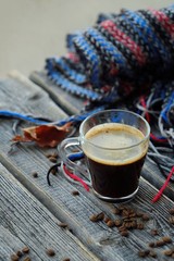 Delicious fresh espresso coffee and beans on wooden table 