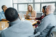 © FS Productions/Blend Images - Businesswoman reading digital tablet in meeting