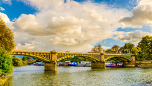 Boats Moored By Twickenham Bridge Spanning Over The River Thames, London U.K