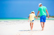 © travnikovstudio - Little girl and dad during tropical beach vacation