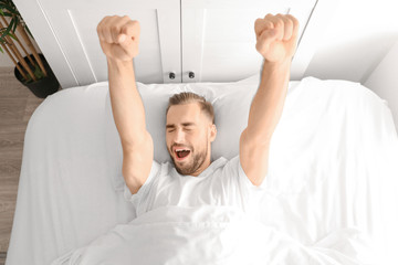 Wall Mural - Morning of handsome man lying in bed at home