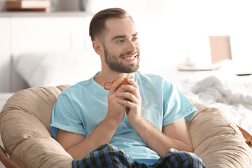 Wall Mural - Morning of handsome young man drinking coffee at home