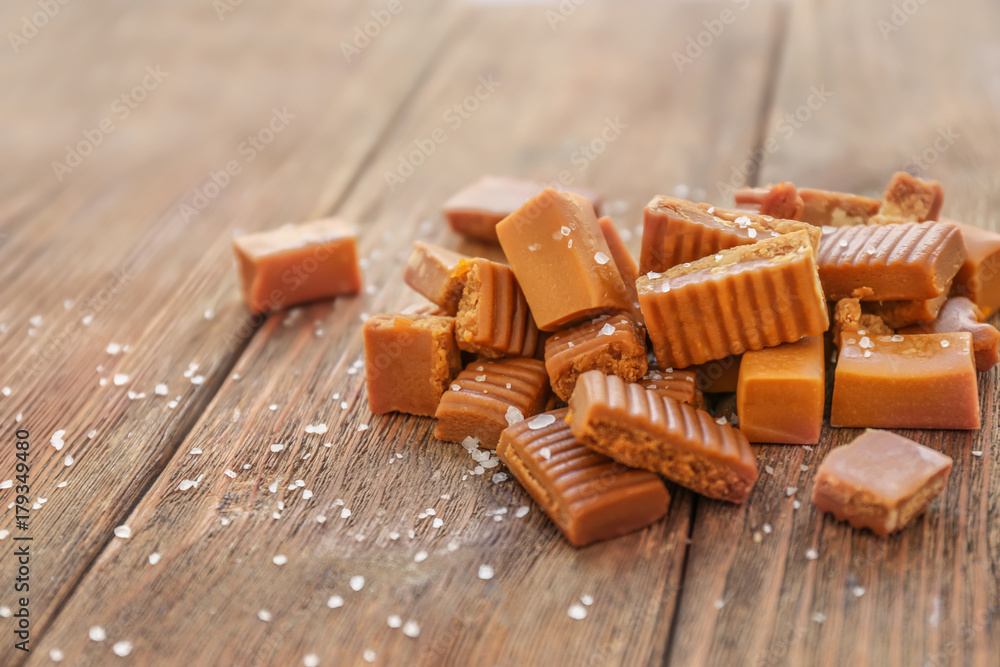 Salted caramel candies on wooden table