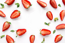 Strawberry Creative Pattern With Copy Space. Sliced Ripe Red Berry With Green Leaves On White Background.