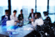© alphaspirit - Silhouette of businessperson in office with network effect. concept of partnership and teamwork