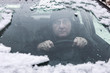 © soupstock - Driver looking through a foggy and snowy car window, soft focus through glass.