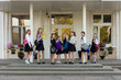 © Nadya Kolobova - A group of schoolgirls with backpacks go to school