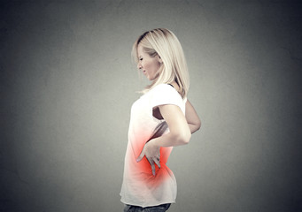 Wall Mural - young woman with lower back pain colored in red