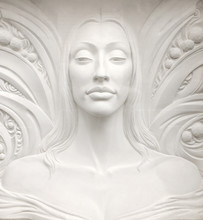 Bas-relief Sculpture Of A Young Woman Face With Tall Neck, Long Hair, And Bare Shoulders