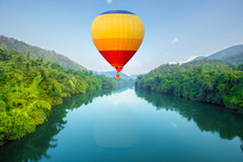 Hot Air Balloons Flying Over River
