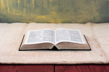 Bible on an old table. Beautiful background.Religion concept.