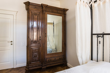 a four-poster bed and an antique wardrobe