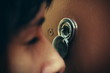 Closeup of woman looking through peephole
