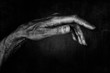 © Maxal Tamor - Black and White photo of senior woman hand on black background