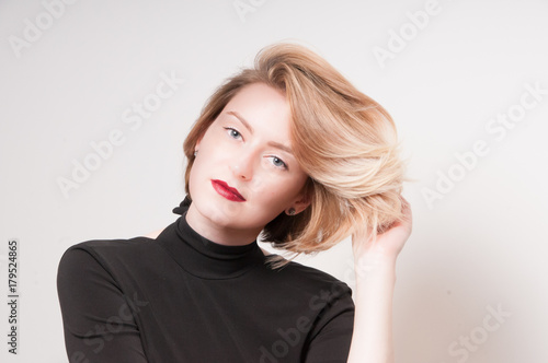 Studio Portrait Of A Blonde Girl With A Short Haircut Of