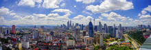 Panorama View Of Kuala Lumpur City Skyline With Dramatic Cloud Formation And Blue Sky.