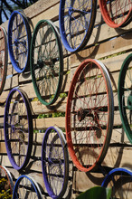 Bicycle Rim Various Colors Hung On The Wall As Decoration.