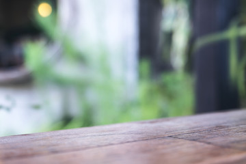 Close up image of a wooden table with blur bokeh of green nature background