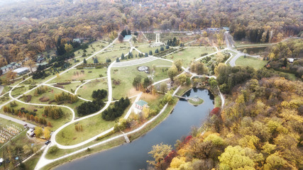 Wall Mural - Aerial view of a waterfall in a tree filled valley