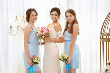 Wall Mural - Happy beautiful bride with bridesmaids on wedding day, indoors