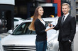 © Africa Studio - Car salesman handing key to woman outdoors