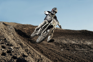 Motocross driver on race track