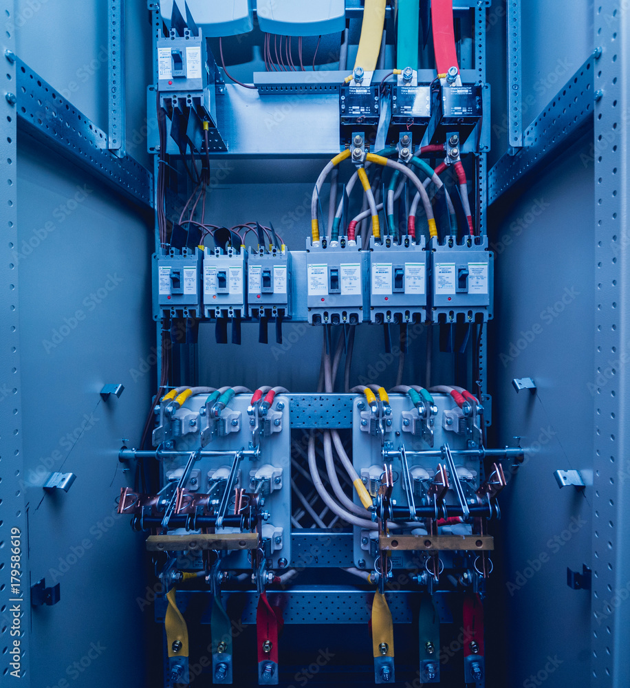 Wires and switches in electric box. Electrical panel with fuses and ...