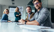 © Jacob Lund - Businesspeople sitting in conference room