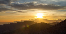 Panoramic Sunset View Over The Desert Mountain Landscape Of Joshua Tree National Park In California
