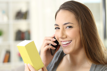 Wall Mural - Girl calling on phone asking information about a product