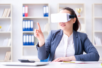 Businesswoman with virtual reality glasses in office