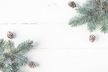 Christmas composition. Frame made of fir branches on white wooden background. Christmas, winter concept. Flat lay, top view, copy space