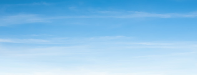 an aerial background view from of clear blue skies and white faint clouds - panoramic web banner