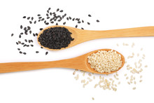Black And White Sesame Seeds In A Wooden Spoon Isolated On White Background Top View