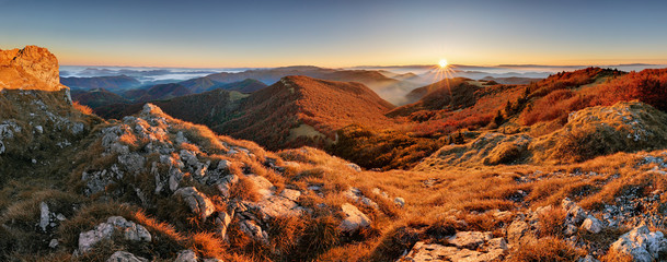 Aufkleber - Panorama of sunset in a Carpathian mountain valley with wonderful gold light on a hills