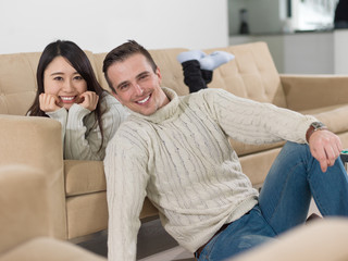 Wall Mural - happy multiethnic couple relaxing at home