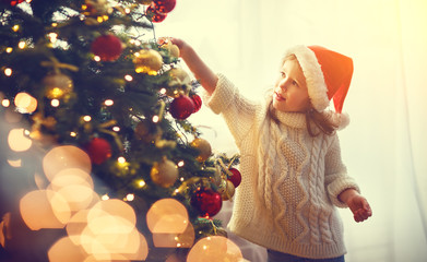 happy child girl decorated Christmas tree